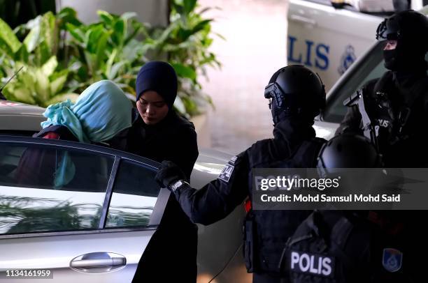 Vietnamese Doan Thi Huong, escorted by police after arriving at court session for her trial at the Shah Alam High Court for murder case of Kim Jong...