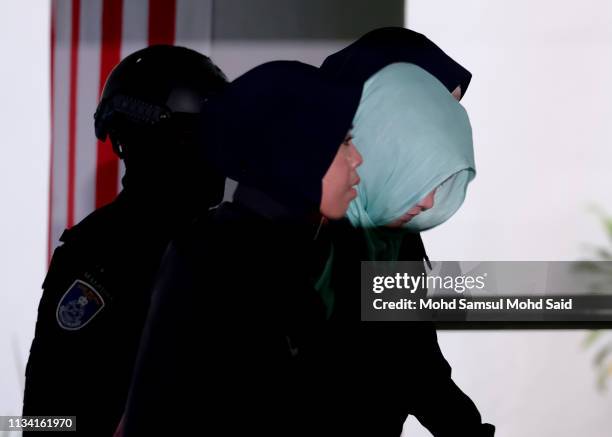 Vietnamese Doan Thi Huong, escorted by police after arriving at court session for her trial at the Shah Alam High Court for murder case of Kim Jong...