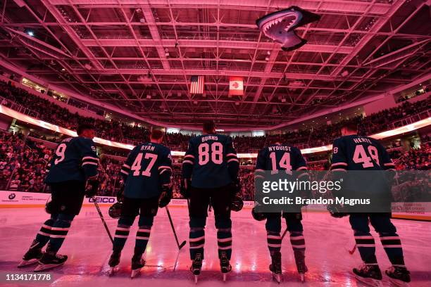 Evander Kane, Joakim Ryan, Brent Burns, Gustav Nyquist and Tomas Hertl of the San Jose Sharks stand for the national anthem against the Calgary...