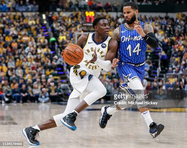 Darren Collison of the Indiana Pacers drives to the basket during the game against D.J. Augustin of the Orlando Magic at Bankers Life Fieldhouse on...