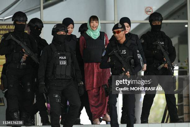Vietnamese national Doan Thi Huong is escorted by Malaysian police out of the High Court in Shah Alam on April 1, 2019. - A Vietnamese woman accused...