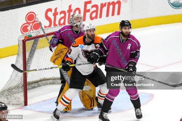 Cleveland Monsters defenceman Tommy Cross defends Lehigh Valley Phantoms right wing Colin McDonald in front of Cleveland Monsters goalie Brad...