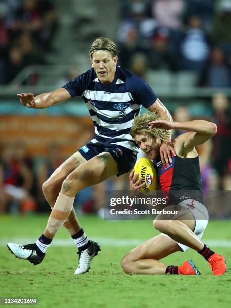 Dyson Heppell of the Bombers is tackled by Rhys Stanley of the Cats during the 2019 JLT Community Series AFL match between the Geelong Cats and the...