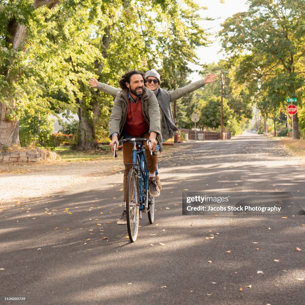 Couple Riding Tandem Bicycle