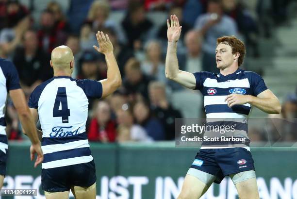 Gary Rohan of the Cats is congratulated by Gary Ablett of the Cats after kicking a goal during the 2019 JLT Community Series AFL match between the...