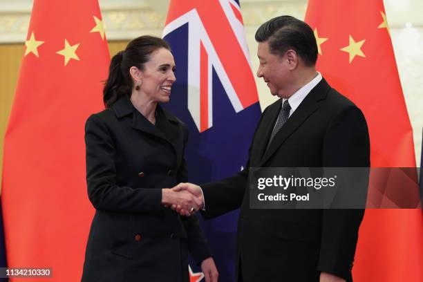 Chinese President Xi Jinping, right and New Zealand Prime Minister Jacinda Ardern, left shake hands before the meeting at the Great Hall of the...