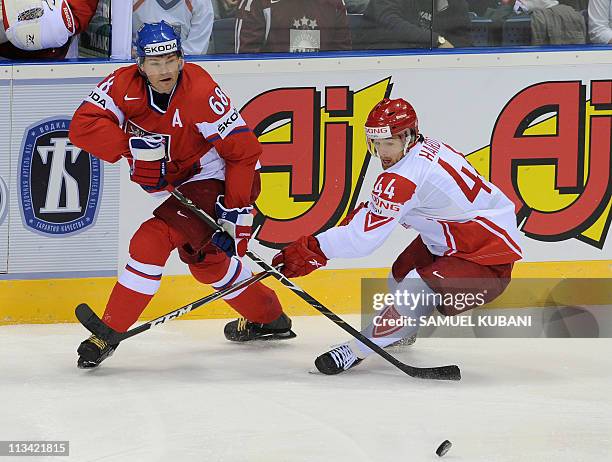 Jaromir Jagr of the Czech Republic fights for a puck with Nichlas Hardt of Denmark during the IIHF Ice Hockey World Championship group D match...