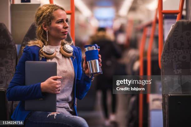 busy businesswoman drinking coffee in train. - oslo train stock pictures, royalty-free photos & images