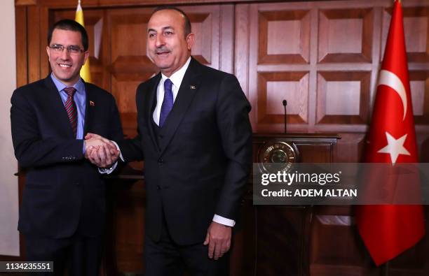 Venezuelan Foreign Minister Jorge Arreaza and Turkish Foreign Minister Mevlut Cavusoglu shake hands during a joint press conference following their...