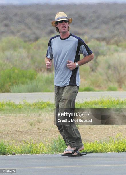 Cameraman Danny Moder runs after saying goodbye to friends at Taos airport on July 6, 2002 in Taos, New Mexico. Moder married actress Julia Roberts...