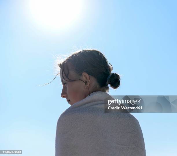 profile of girl at backlight wrapped in a towel - wrapped in a towel stock-fotos und bilder