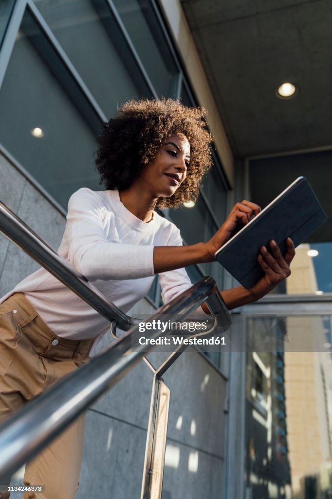 Young casual businesswoman using smartphone