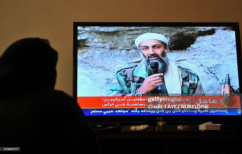 A Saudi woman watches images on Arabic s