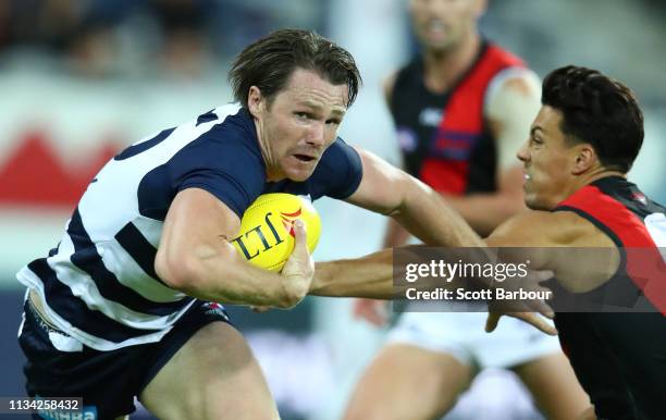 Patrick Dangerfield of the Cats beats the tackle of Dylan Shiel of the Bombers during the 2019 JLT Community Series AFL match between the Geelong...