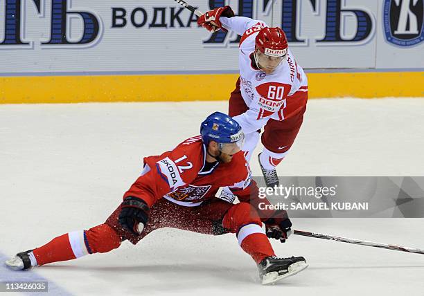 Jiri Novotny of the Czech Republic fights for a puck with Mads Christensen of Denmark during the IIHF Ice Hockey World Championship group D match...