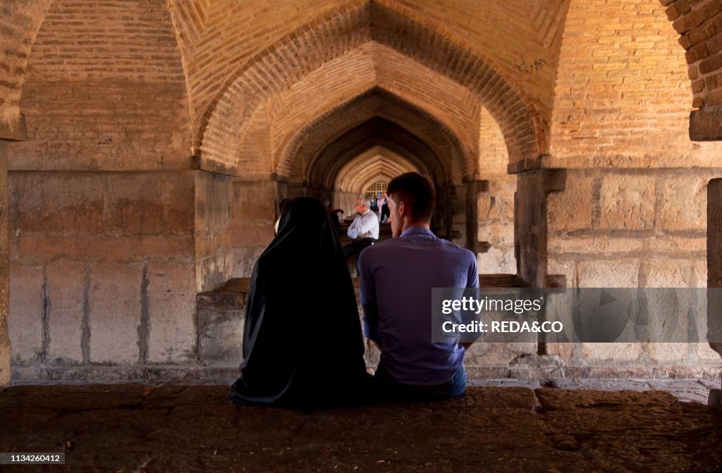 A couple inside the Khaju Bridge at Isfahan