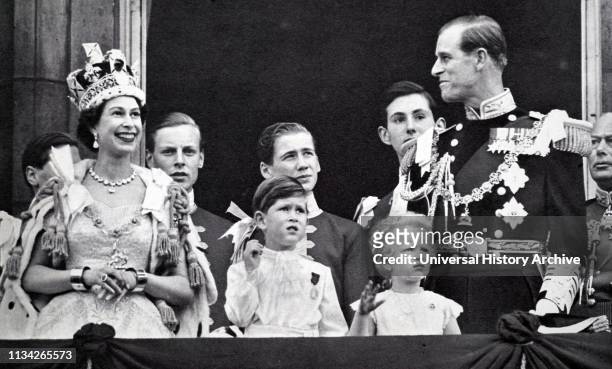 Buckingham Palace balcony. Coronation day 1953. The Queen and the Duke exchange smiles while Prince Charles and Princess Anne are absorbed with the...