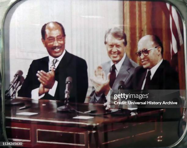 Jimmy Carter. Seated with Egyptian President Anwar Sadat and Israeli Prime Minister Menachem Begin. Makes statements. Following the Camp David...