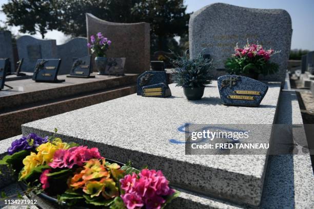 Picture taken on April 1, 2019 shows a grave vandalised with spray-painted swastikas at a cemetery in Ploermel, western France.