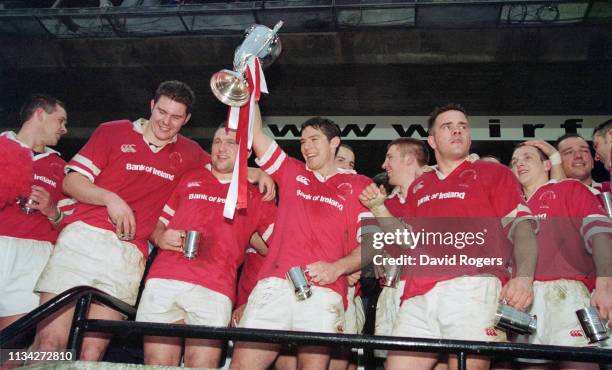 Ulster player Simon Mason lifts the trophy as team mates look on after victory in the 1999 Heineken Cup Final against Colomiers at Landsdowne Road on...