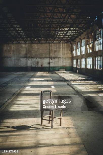 a chair in the abandoned factory building - 舊式 stock pictures, royalty-free photos & images