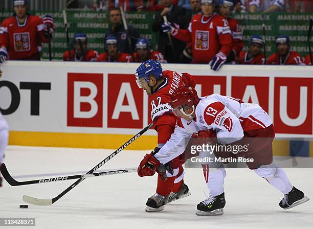 Tomas Plekanec of Czech Republic and Morten Green of Denmark battle for the puck during the IIHF World Championship group D match between Czech...