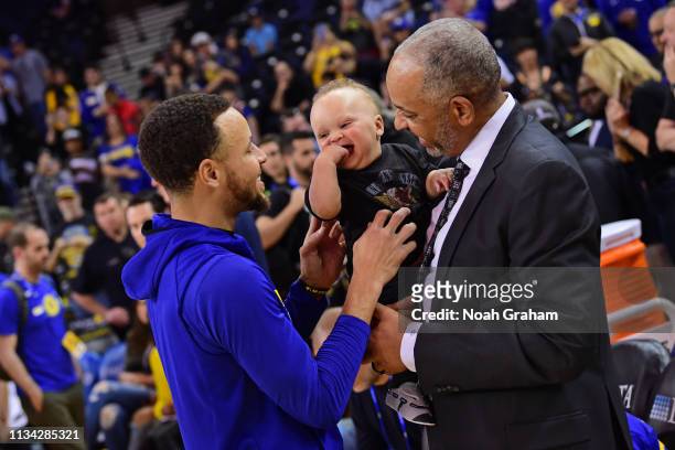 Stephen Curry of the Golden State Warriors, Canon Jack Curry and Dell Curry talk before the game against the Charlotte Hornets on March 31, 2019 at...