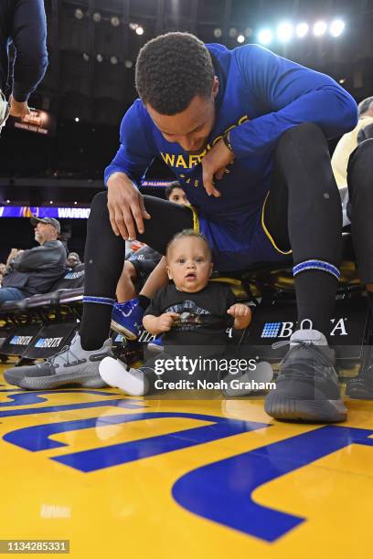 Stephen Curry of the Golden State Warriors and his son, Canon Jack Curry, pose for a photo before the game against the Charlotte Hornets on March 31,...