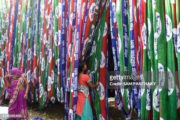 Indian worker dry textile materials dedicated to the Lok Janshakti Party ahead of India's general election, on the outskirts of Ahmedabad on April 1,...