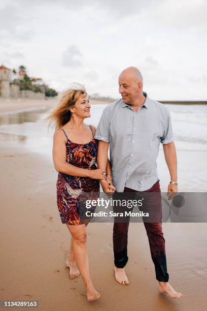 couple taking walk on beach, estoril, lisboa, portugal - 2 peas in a pod stock pictures, royalty-free photos & images