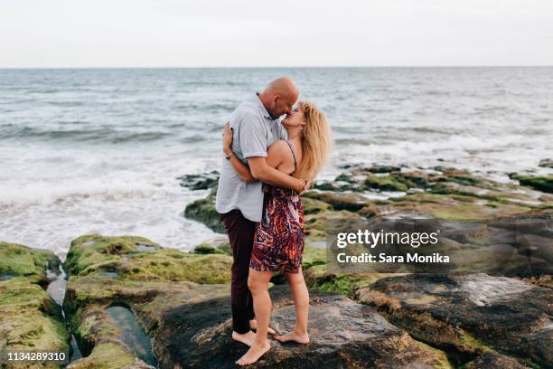 couple hugging and kissing on beach, estoril, lisboa, portugal - 2 peas in a pod stock pictures, royalty-free photos & images