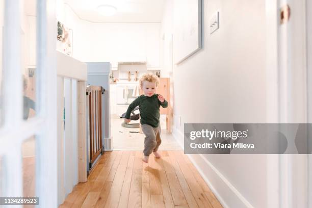 boy running along corridor - running indoors stock pictures, royalty-free photos & images