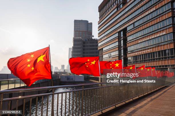 row of chinese flags on huangpu river promenade, shanghai, china - china flag stock pictures, royalty-free photos & images