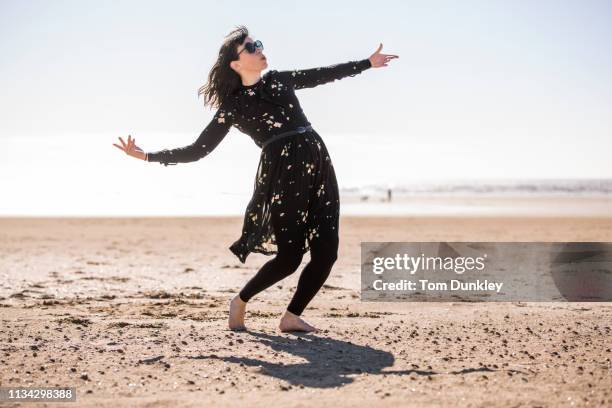 woman dancing on beach - bending over backwards stock pictures, royalty-free photos & images