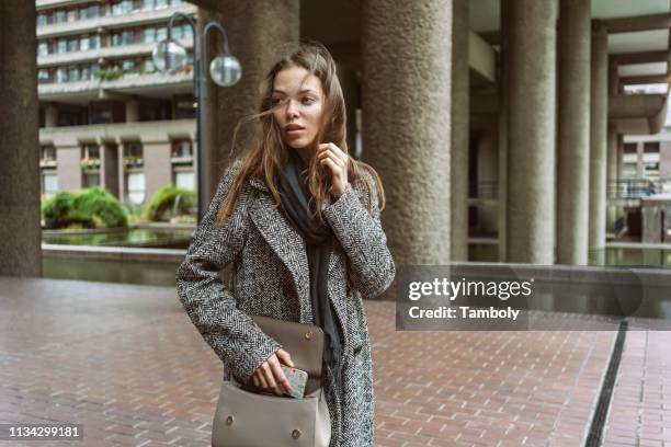 young woman on walkway of office building, london, uk - london from the air stock-fotos und bilder