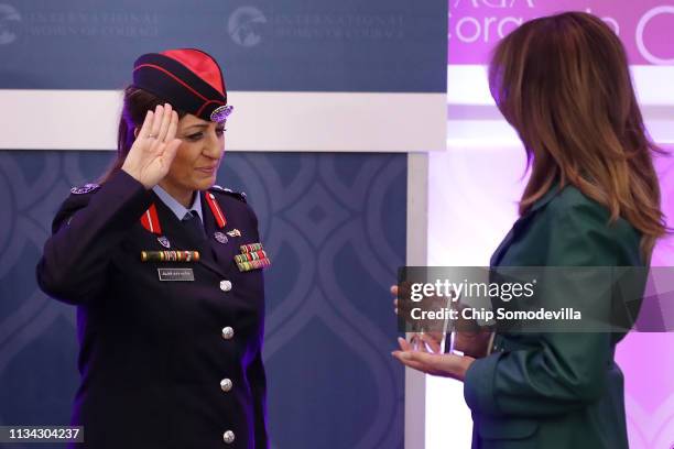 Colonel Khalida Khalaf Hanna al-Twal of Jordan salutes as U.S. First lady Melania Trump presents her with the International Women of Courage Award...