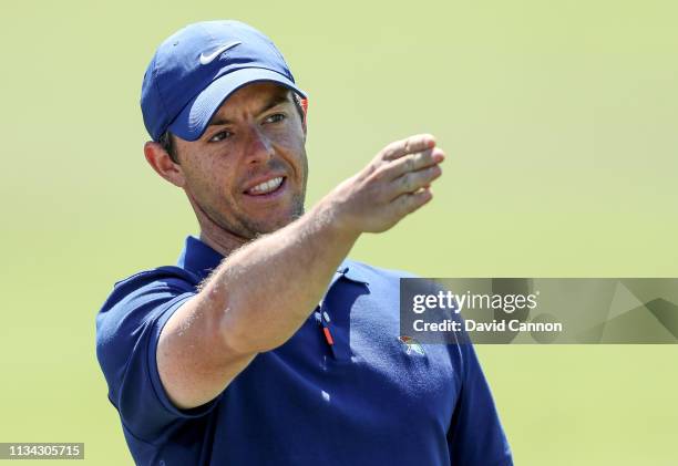 Rory McIlroy of Northern Ireland prepares to play his second shot on the par 4, first hole wearing a special Nike golf shirt sporting the Arnold...