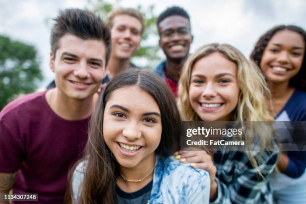 friends taking a picture together - multiracial group teenagers stock pictures, royalty-free photos & images