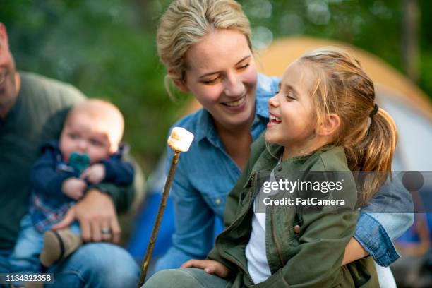 Family Roasting Marshmallows In Campground High-Res Stock Photo