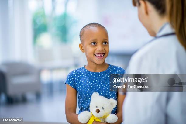 cuddling teddy - childhood cancer stock pictures, royalty-free photos & images