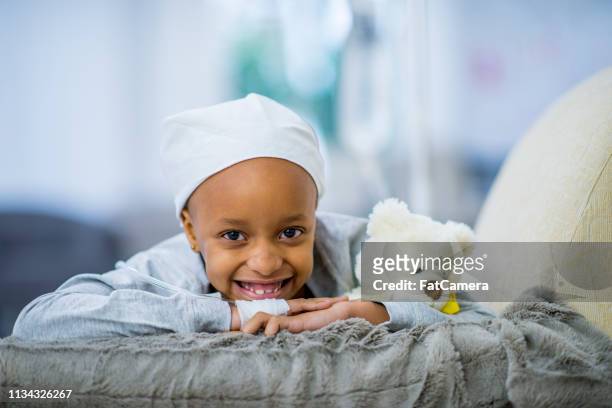 smiling girl with cancer - childhood cancer stock pictures, royalty-free photos & images