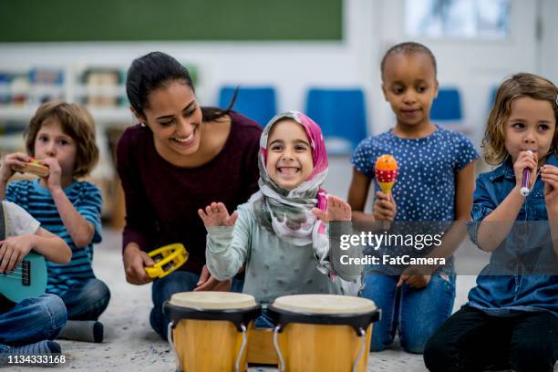 playing instruments - refugee education stock pictures, royalty-free photos & images