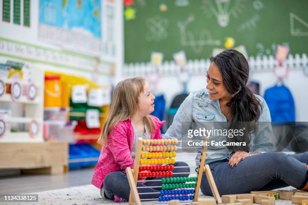 learning to use an abacus - special needs children stock pictures, royalty-free photos & images