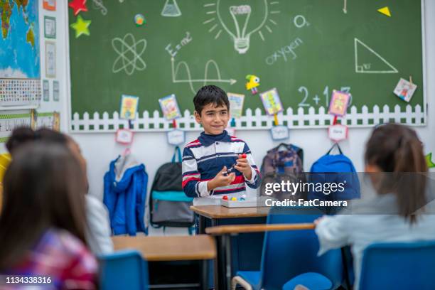 in a classroom - boy giving speech stock pictures, royalty-free photos & images
