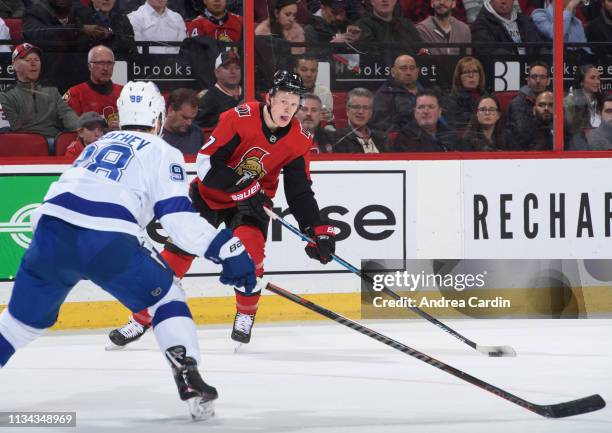 Brady Tkachuk of the Ottawa Senators fires a shot with pressure from Mikhail Sergachev of the Tampa Bay Lightning at Canadian Tire Centre on April 1,...