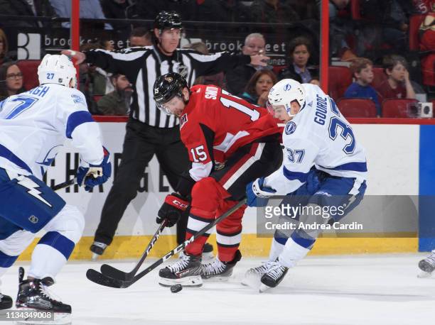 Zack Smith of the Ottawa Senators battles for a loose puck with Yanni Gourde of the Tampa Bay Lightning at Canadian Tire Centre on April 1, 2019 in...