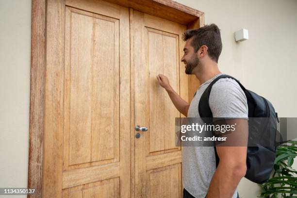 homme de déplacement frappant à la porte d'une maison d'hébergement - knocking photos et images de collection