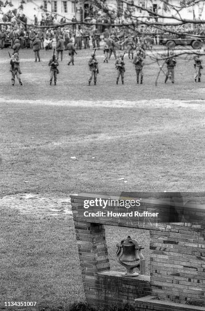 View, past the Kent State University Victory Bell , of a line of Ohio National Guardsman assembled on the Commons, Kent, Ohio, May 4, 1970. The...