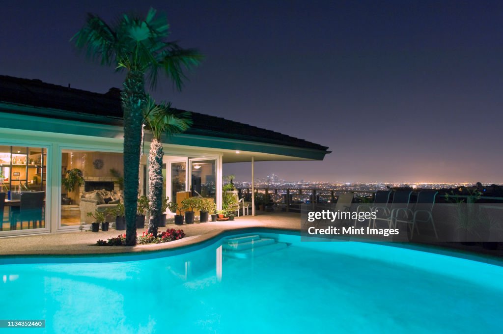 Illuminated pool at night with city in background, Los Angeles, California, United States