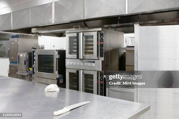 stainless steel appliances in restaurant kitchen - commercial kitchen stock pictures, royalty-free photos & images